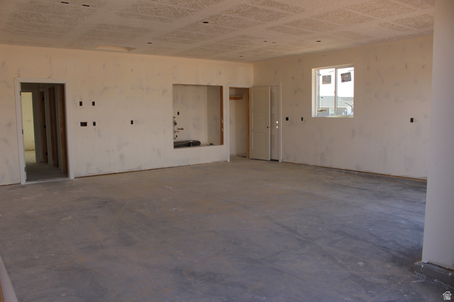 4933 East Remington Road Cedar City, UT 84721 - Photo 4 of 33 Spacious room under construction featuring a concrete subfloor, multiple doorways, and a recessed wall niche