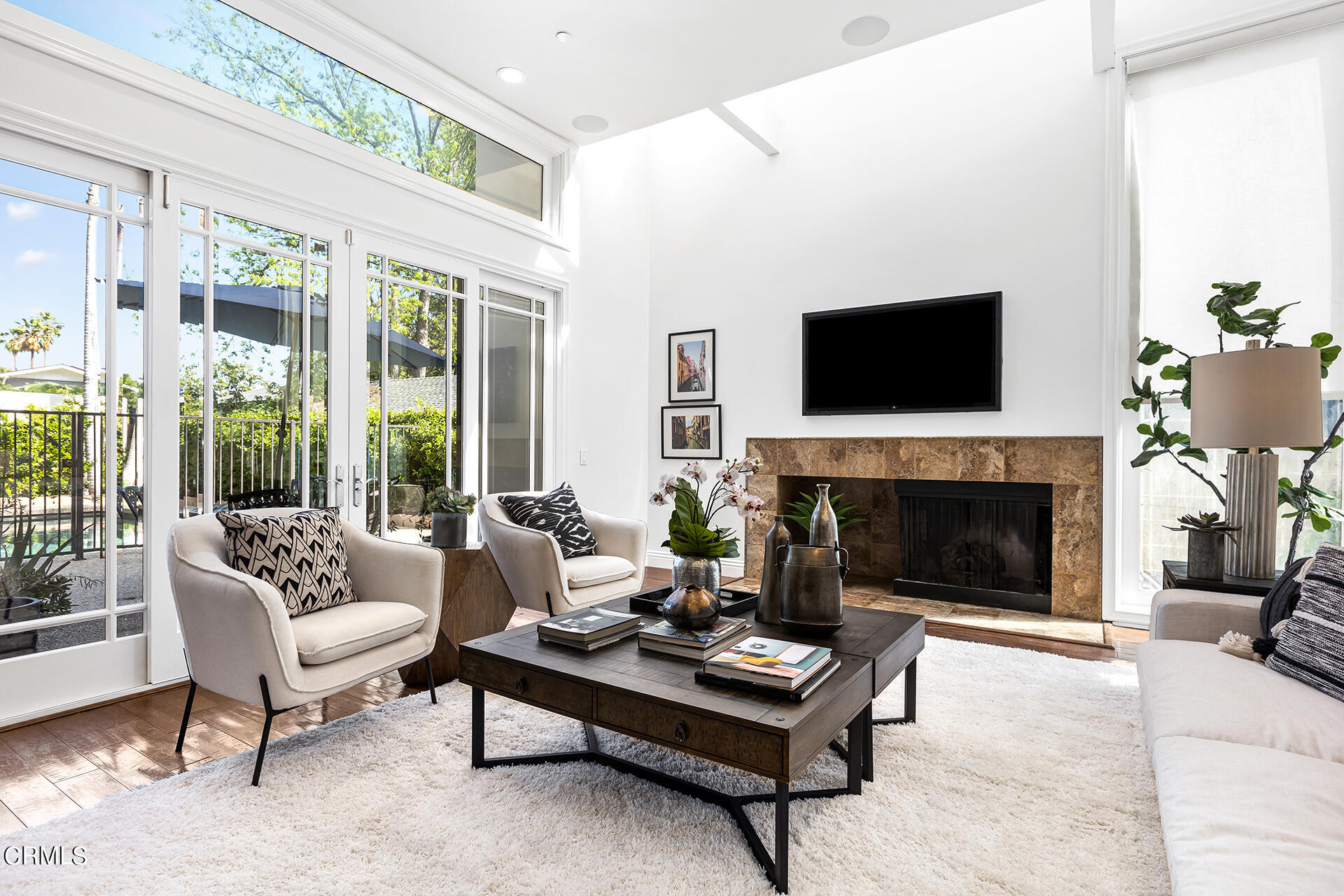 Undisclosed Address Pasadena, CA 91106 - Photo 6 of 31 a living room with furniture a fireplace and a flat screen tv