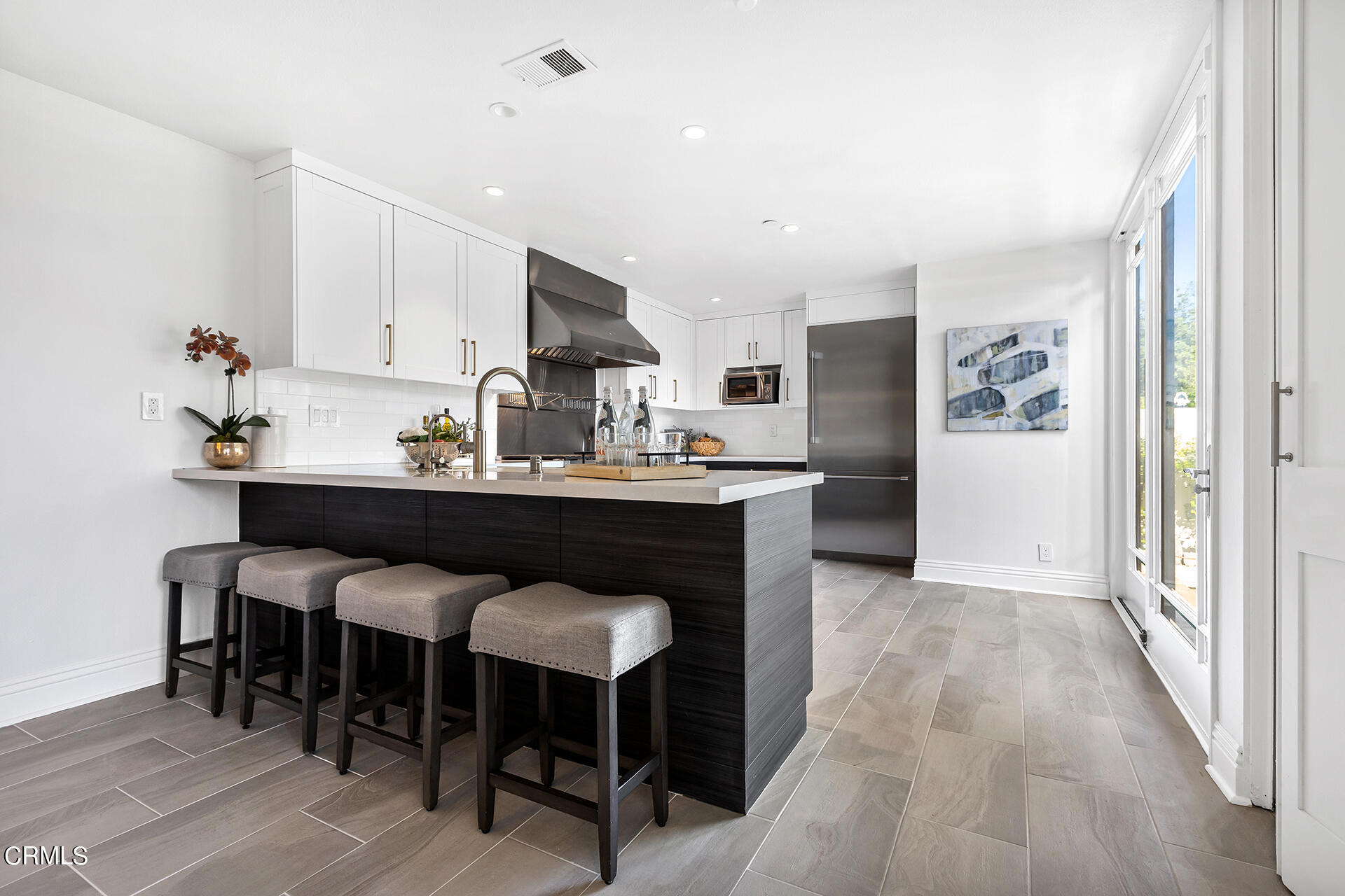 Undisclosed Address Pasadena, CA 91106 - Photo 10 of 31 a kitchen with stainless steel appliances a sink stove and cabinets