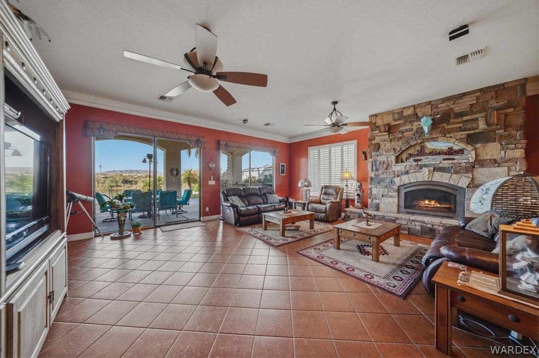1084 Dike Road Mohave Valley, AZ 86440 - Photo 19 of 75 a living room with furniture a fireplace and a flat screen tv