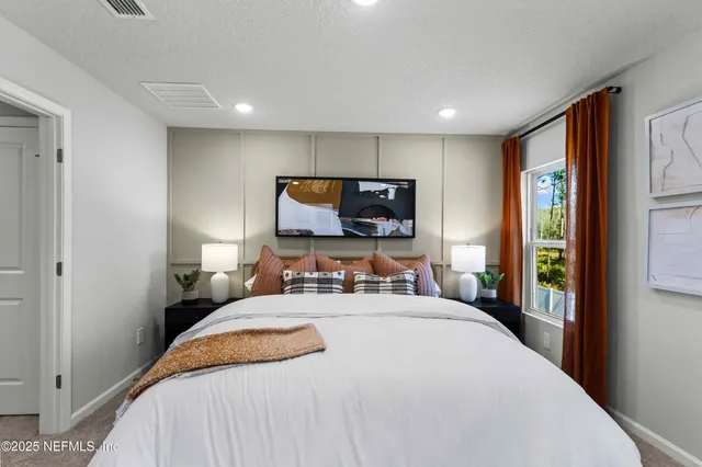 a spacious bedroom with a large bed and a dresser