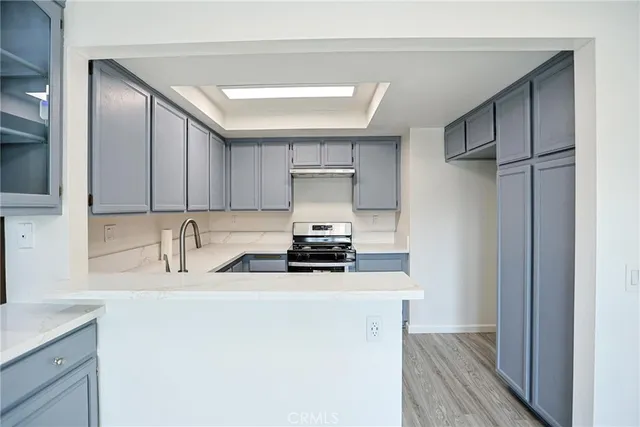 a kitchen with stainless steel appliances a sink stove and cabinets