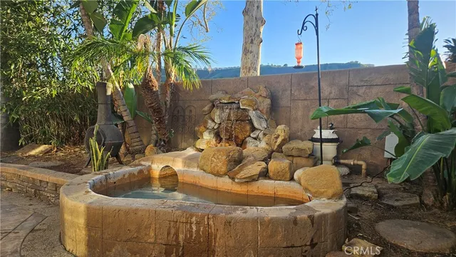 a view of a patio with table and chairs and potted plants