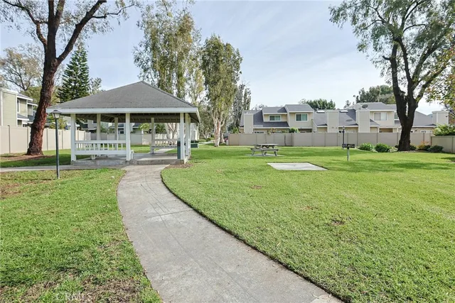 a view of a house with a yard and tree s