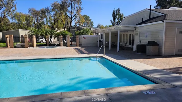 a white house that has a tree in front of it
