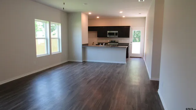 a view of kitchen and microwave with wooden floor