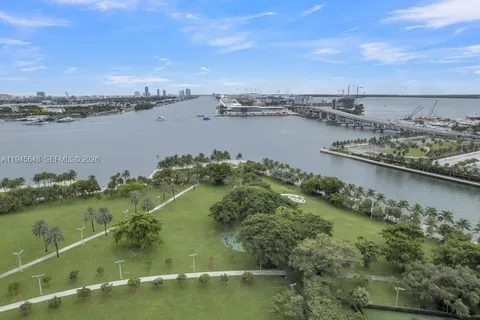 an aerial view of residential houses with outdoor space and lake view