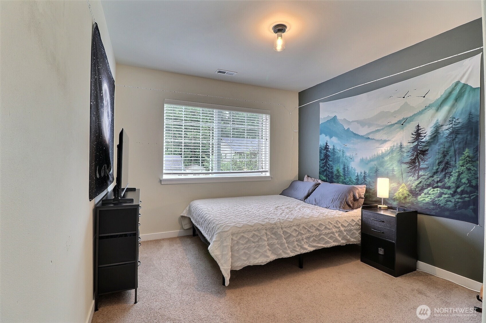 19776 Mountain Ridge Road Southeast Monroe, WA 98272 - Photo 28 of 40 a bedroom with a bed and a flat tv screen on the dresser