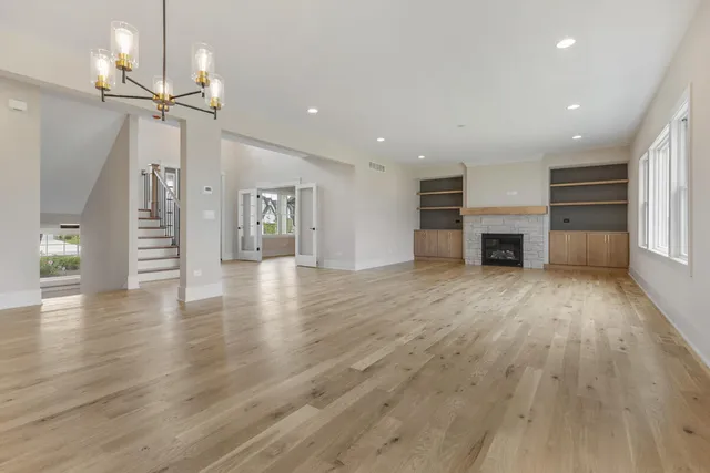 a view of a livingroom with a fireplace wooden floor and window