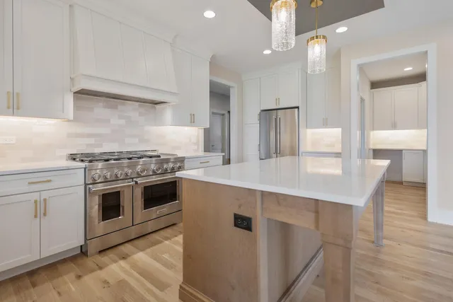 a kitchen with a stove and a kitchen island