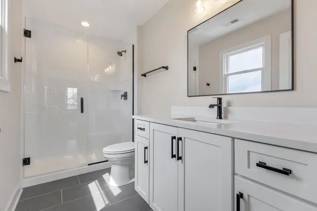 an empty room with windows and ceiling fan