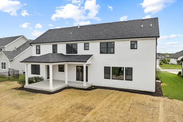 an aerial view of a house with a yard and sitting area