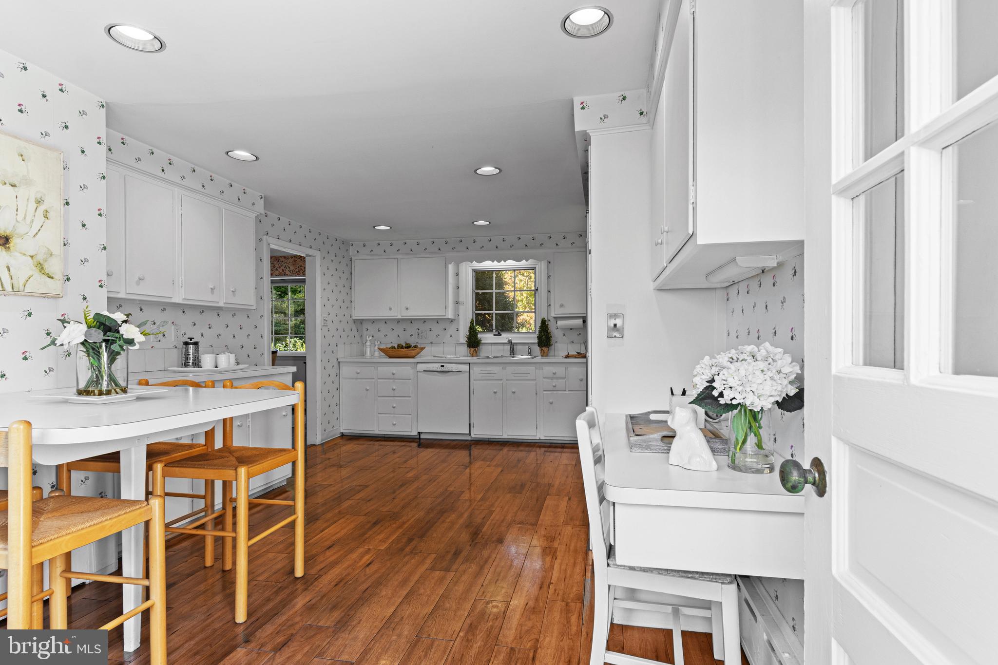 590 Cricket Lane Wayne, PA 19087 - Photo 24 of 65 a large white kitchen with lots of counter space wooden floor and appliances