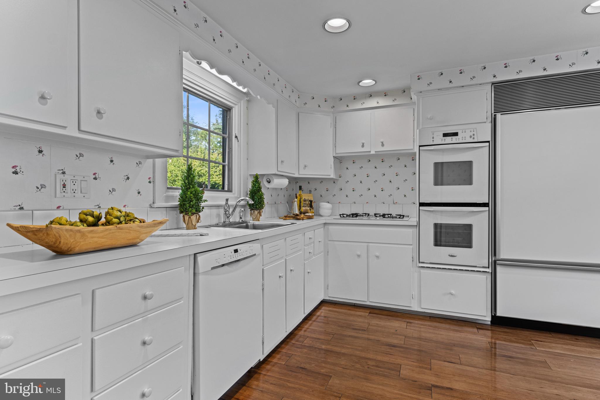 590 Cricket Lane Wayne, PA 19087 - Photo 25 of 65 a kitchen with granite countertop white cabinets and white appliances