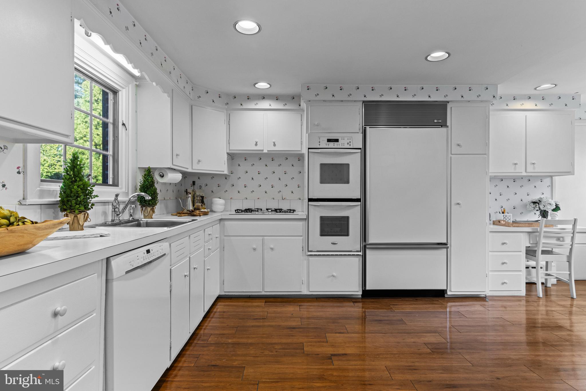 590 Cricket Lane Wayne, PA 19087 - Photo 27 of 65 a kitchen with kitchen island white cabinets and white appliances