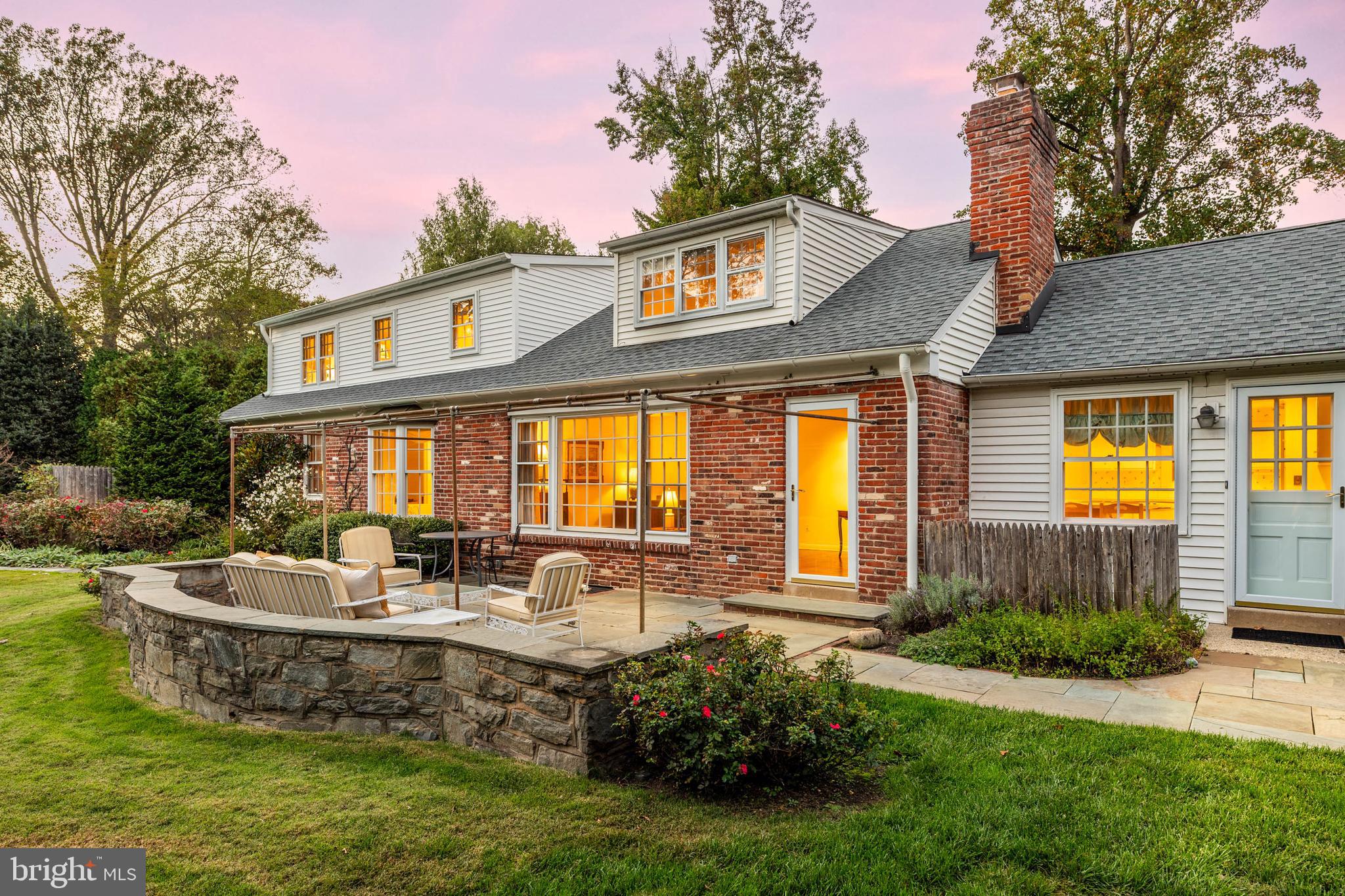 590 Cricket Lane Wayne, PA 19087 - Photo 4 of 65 a front view of a house with swimming pool lawn chairs and a yard