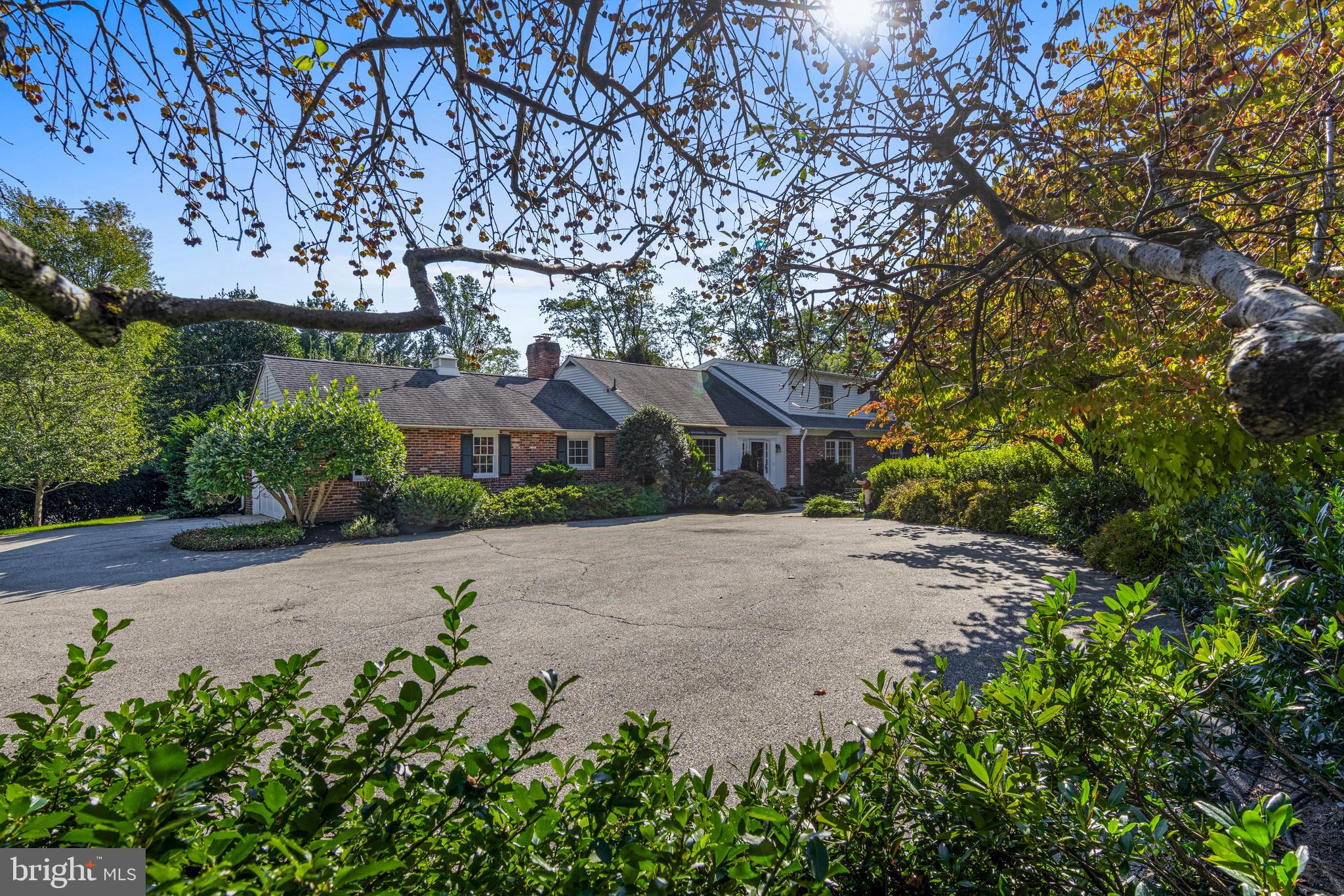 590 Cricket Lane Wayne, PA 19087 - Photo 7 of 65 a front view of a house with a yard and trees