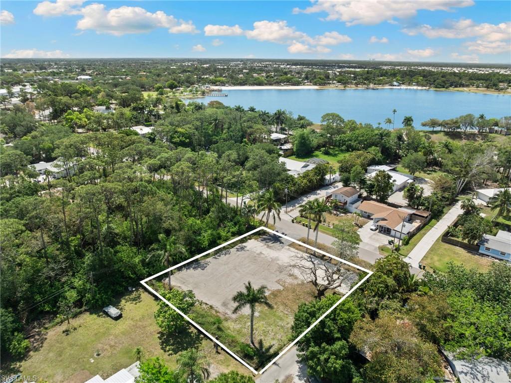 an aerial view of residential houses with outdoor space and lake view