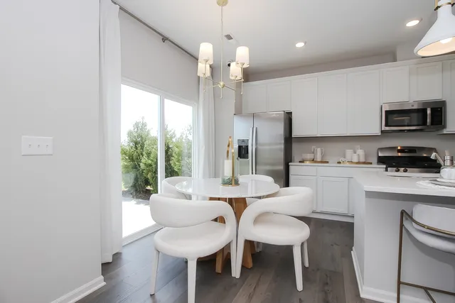 a kitchen with a table and chairs