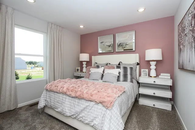 a bedroom with a bed and a large window