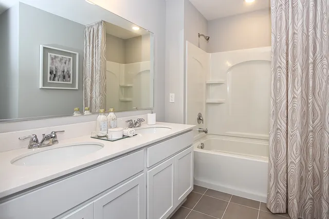 a bathroom with a granite countertop sink a toilet and shower