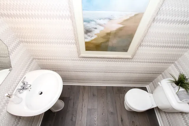 a bathroom with a toilet sink and mirror