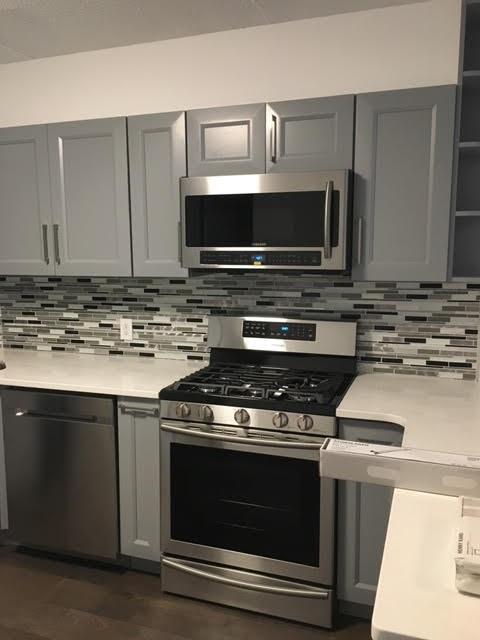 147 Bay 20th Street, Unit 6 Brooklyn, NY 11214 - Photo 2 of 10 a kitchen with cabinets and stainless steel appliances