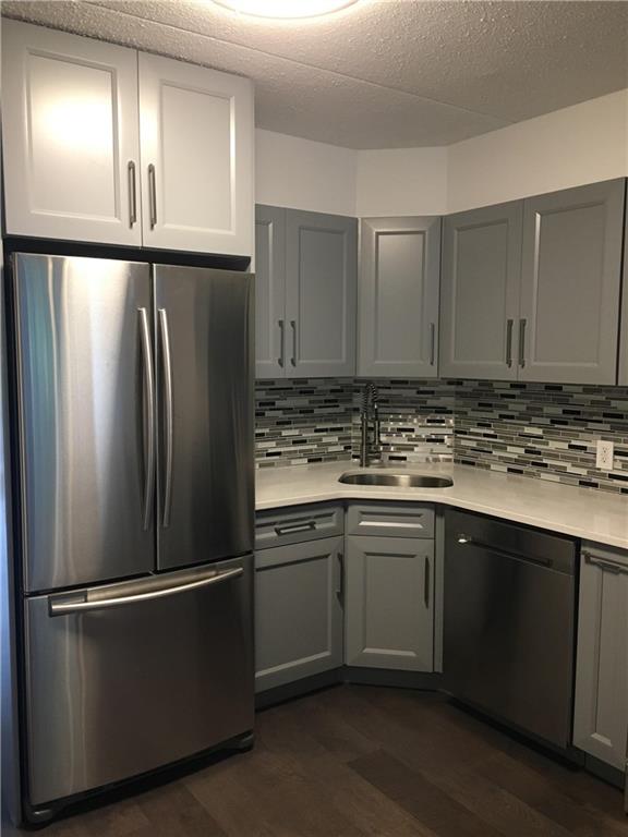 147 Bay 20th Street, Unit 6 Brooklyn, NY 11214 - Photo 3 of 10 a kitchen with stainless steel appliances granite countertop a refrigerator and a sink