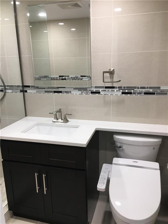 147 Bay 20th Street, Unit 6 Brooklyn, NY 11214 - Photo 4 of 10 a bathroom with a sink and a mirror