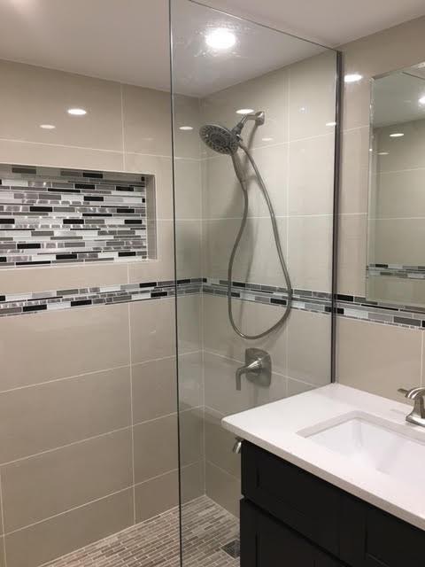 147 Bay 20th Street, Unit 6 Brooklyn, NY 11214 - Photo 5 of 10 a bathroom with a sink a mirror and a shower