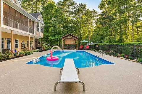 a view of swimming pool with a yard and plants