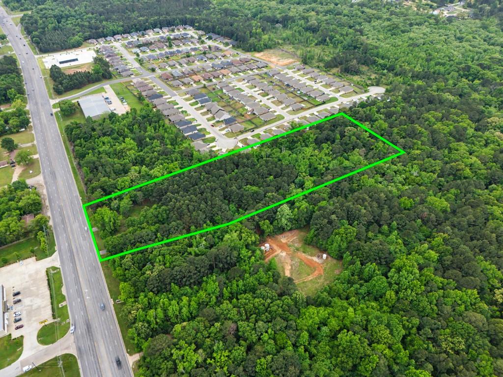 4107 Judson Road Longview, TX 75605 - Photo 5 of 8 Expansive wooded acreage featuring significant tree coverage and direct road frontage