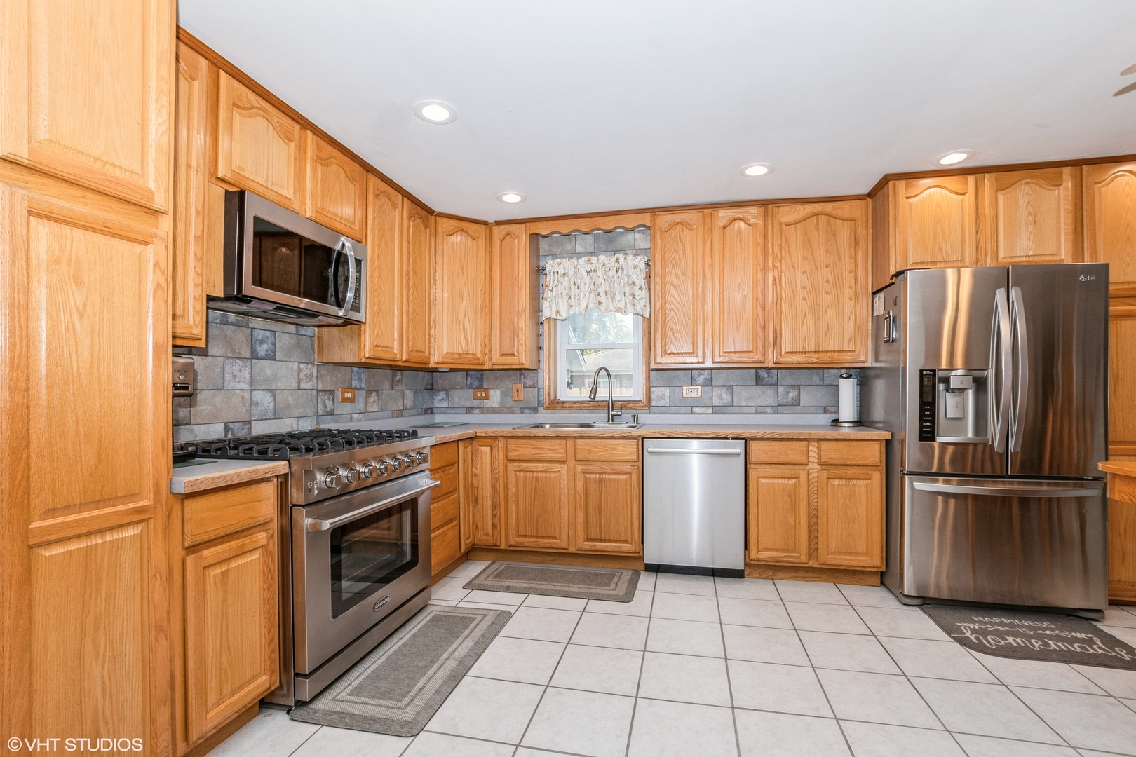 5837 109th Place Chicago Ridge, IL 60415 - Photo 7 of 20 a kitchen with stainless steel appliances granite countertop a refrigerator a stove top oven a sink and dishwasher