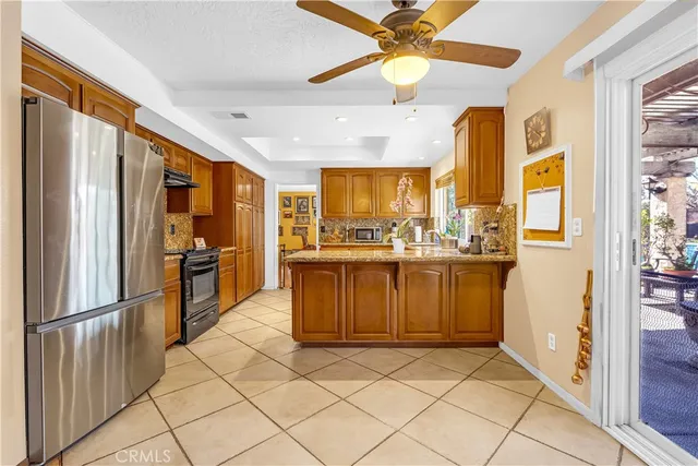 a kitchen with stainless steel appliances granite countertop a refrigerator and a sink