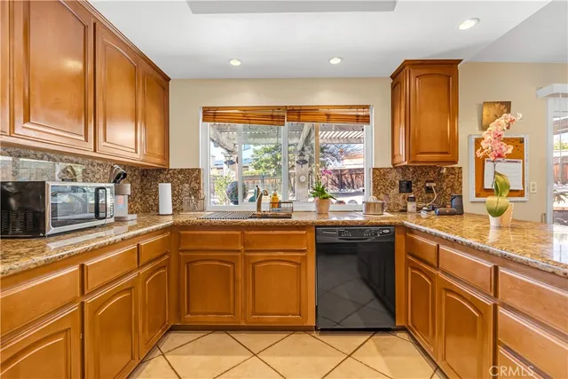 a kitchen with stainless steel appliances granite countertop a sink and cabinets