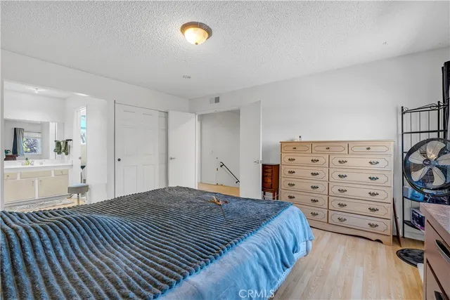 a bedroom with a bed and a cabinets