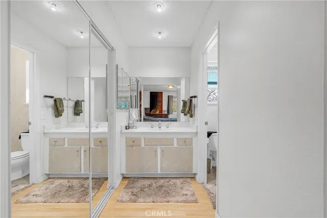 a spacious bathroom with a granite countertop sink a mirror and shower