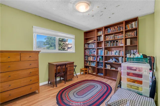 a living room with furniture and a book shelf