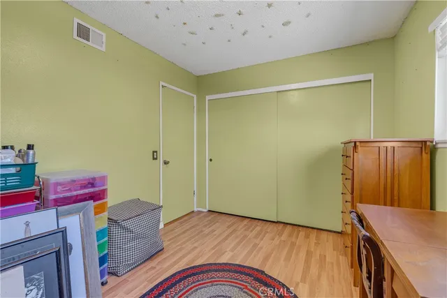 a room with a bed and wooden floor