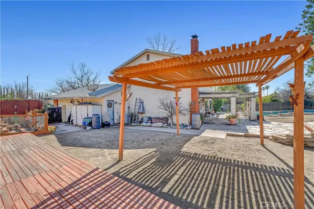 a view of a patio with a table and chairs under an umbrella with wooden floor