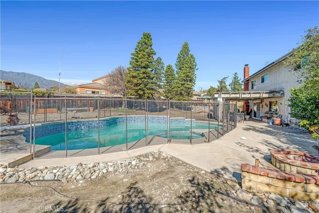 a backyard of a house with a fire pit and outdoor seating