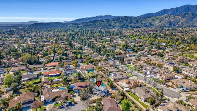an aerial view of a houses with a street