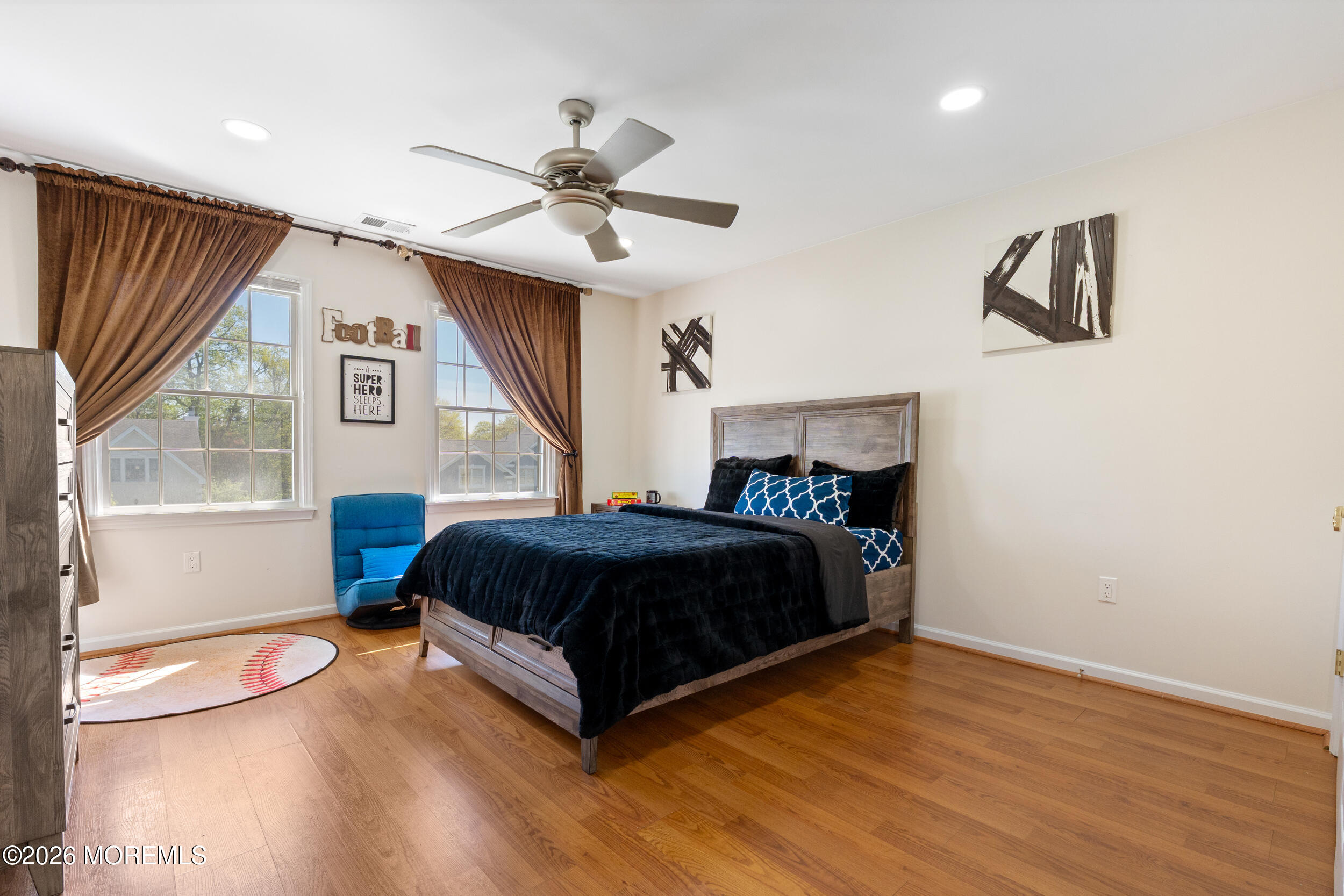 104 Autumn Road Matawan, NJ 07747 - Photo 37 of 64 a bedroom with a bed and a chandelier