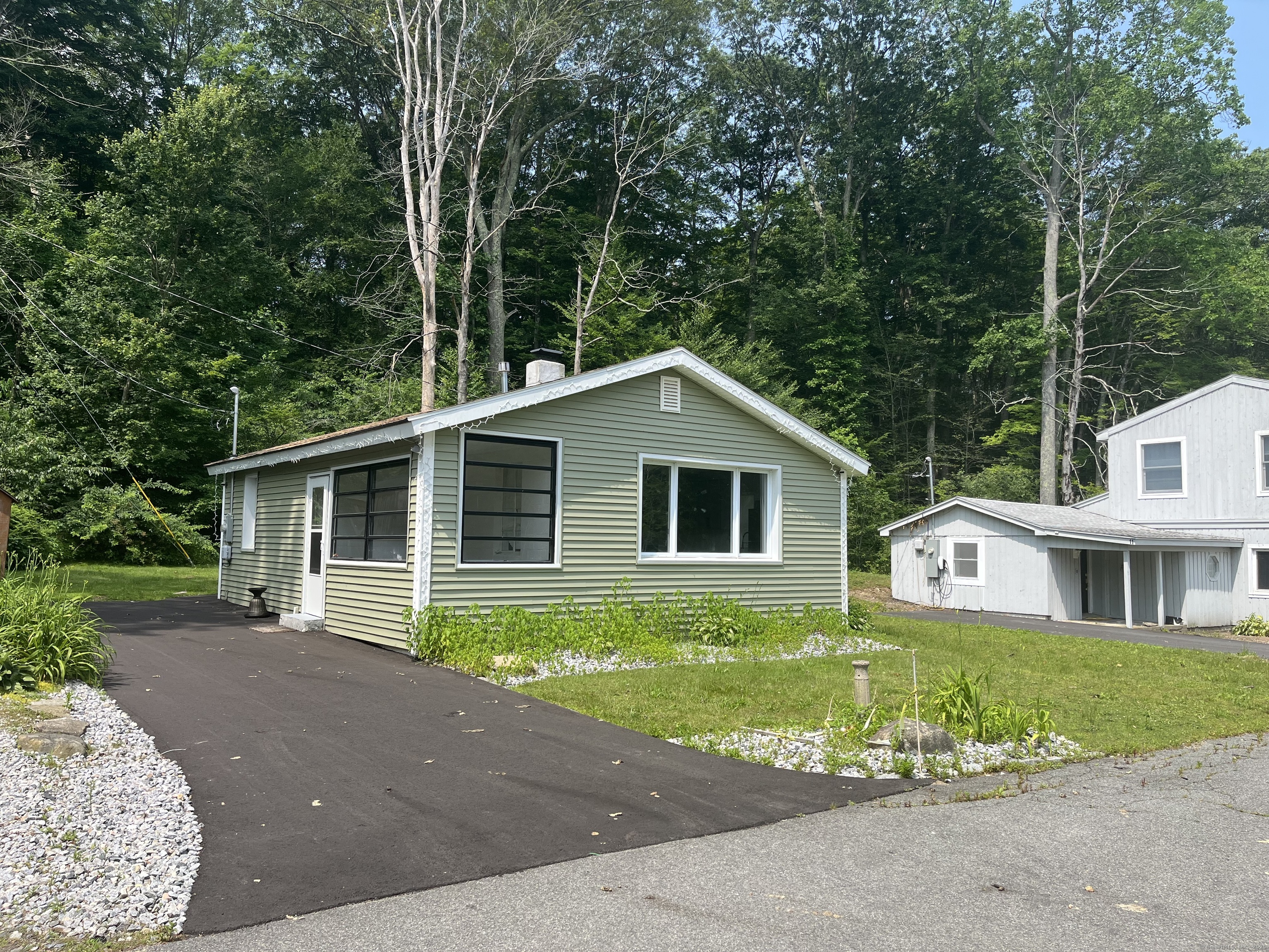 538 Winthrop Road Deep River, CT 06417 - Photo 1 of 11 a front view of a house with a garden and yard