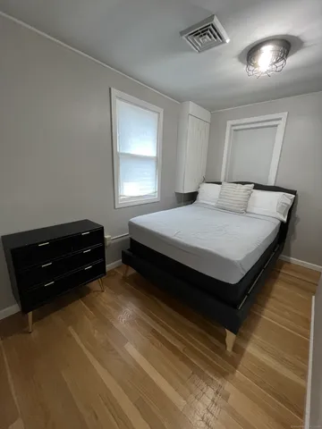 a bedroom with a bed and a window