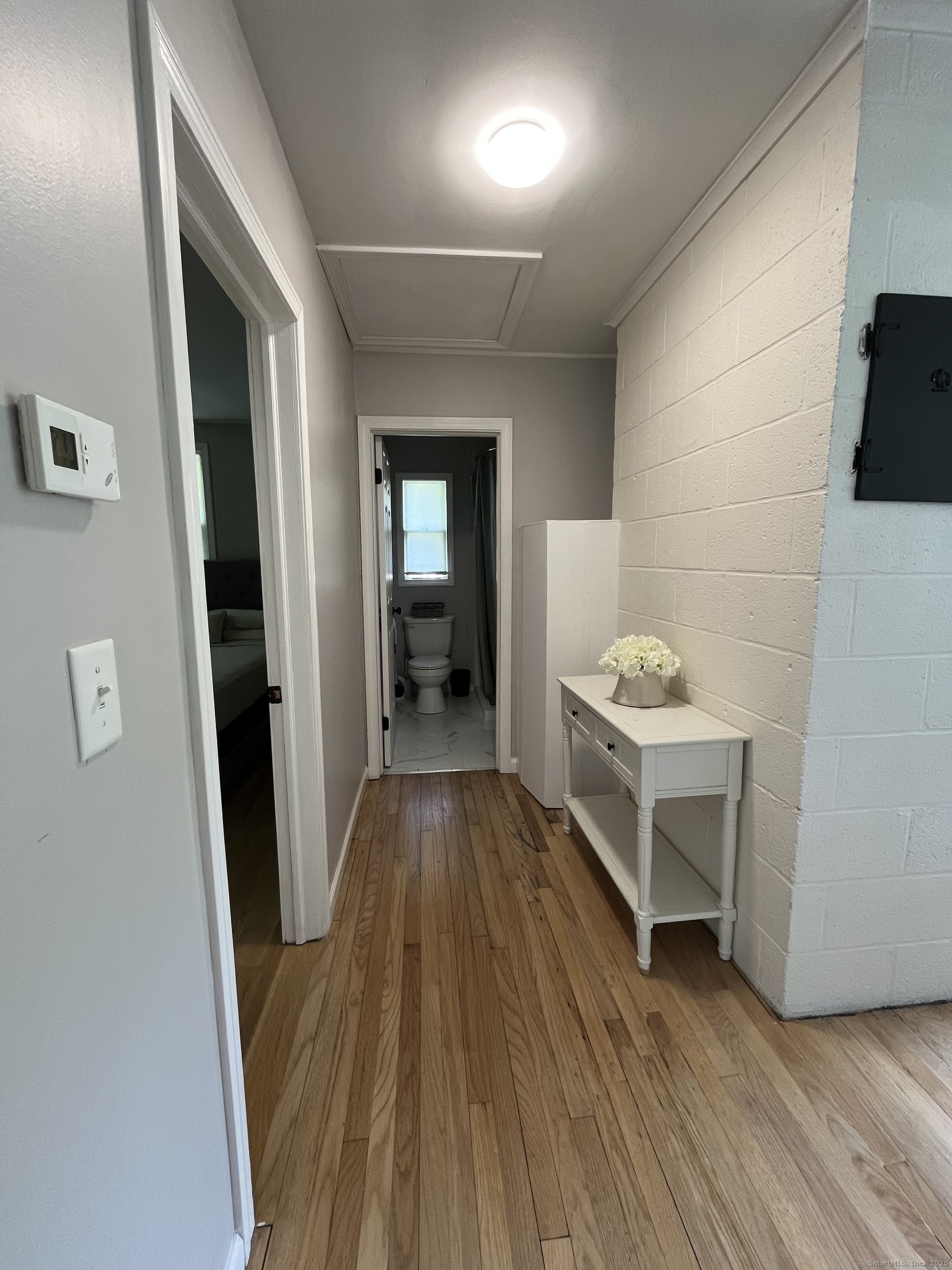 538 Winthrop Road Deep River, CT 06417 - Photo 7 of 11 a view of a hallway with wooden floor and a sink