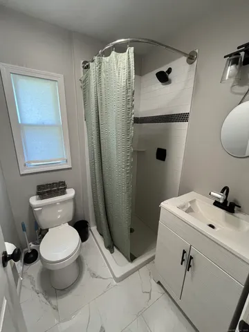 a bathroom with a sink toilet and shower