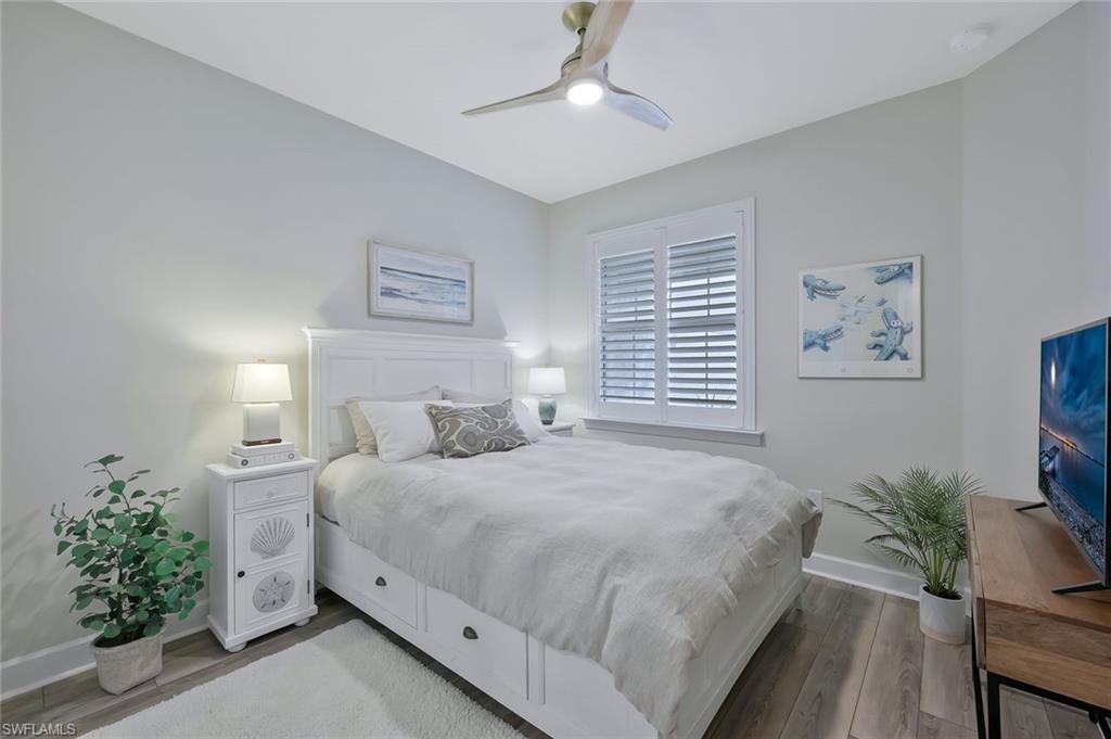 10787 Manatee Key Lane Estero, FL 33928 - Photo 14 of 31 a bedroom with a large bed and a potted plant