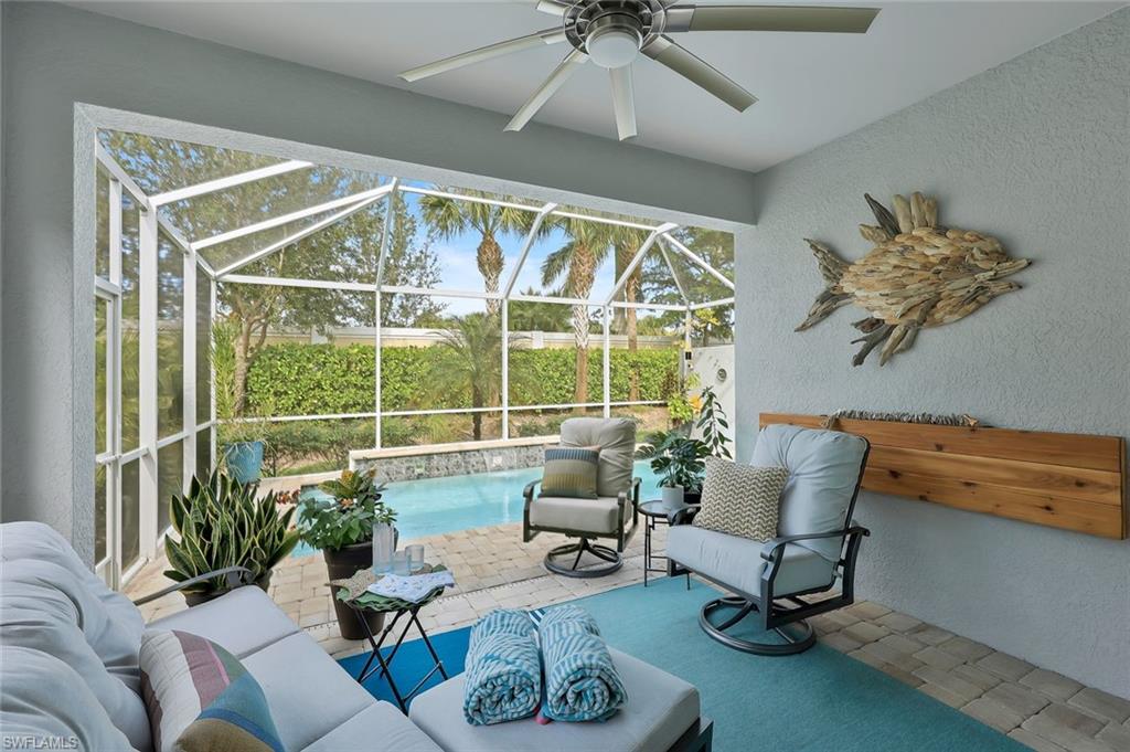 10787 Manatee Key Lane Estero, FL 33928 - Photo 18 of 31 a living room with furniture and a floor to ceiling window
