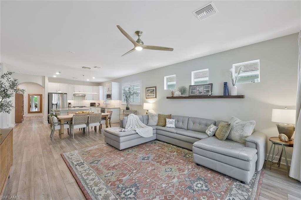 10787 Manatee Key Lane Estero, FL 33928 - Photo 4 of 31 a living room with furniture and view of kitchen